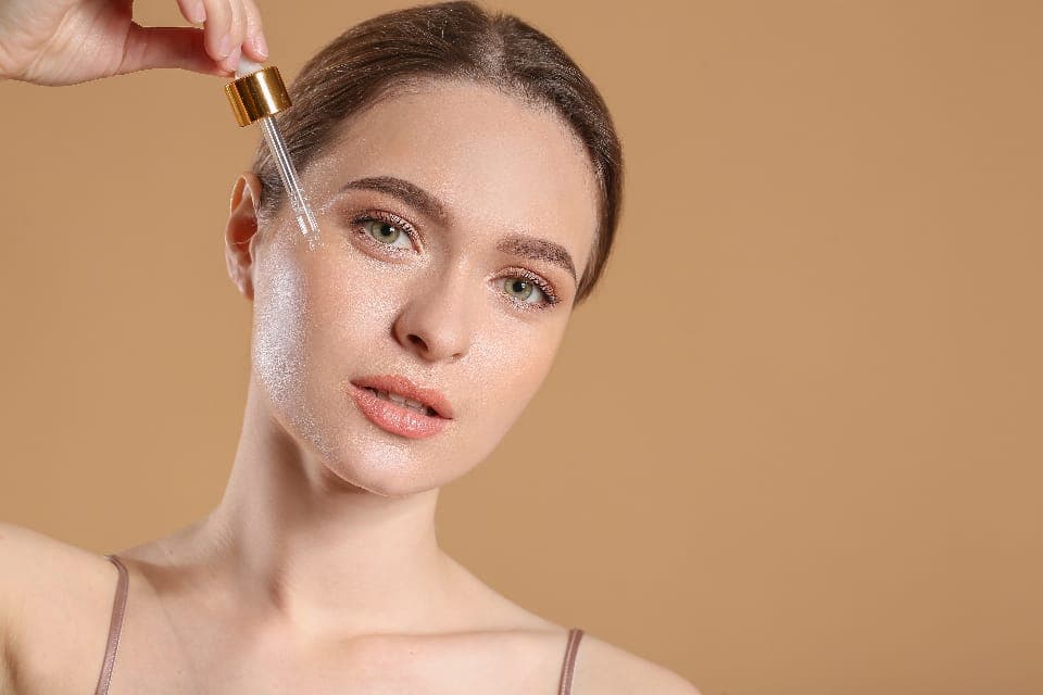 Nhỏ serum lên má bằng ống nhỏ giọt